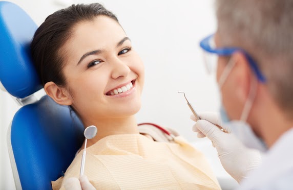 Woman smiles while at her teeth cleaning appointment